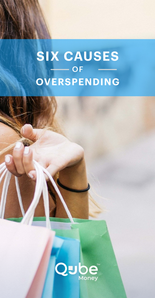 A woman holding shopping bags walking away who is overspending
